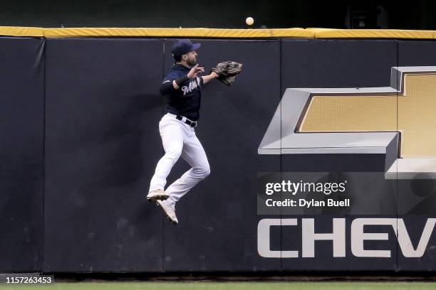 Ryan Braun of the Milwaukee Brewers looks on as a home run hit by Jose Iglesias of the Cincinnati Reds clears the fence in the fifth inning at Miller...