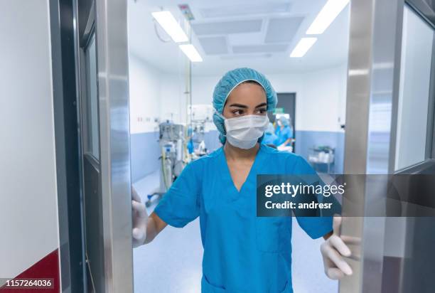 surgeon leaving the operating room - doctor leaving stock pictures, royalty-free photos & images