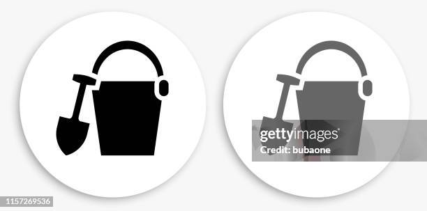 sand bucket black and white round icon - sand bucket stock illustrations