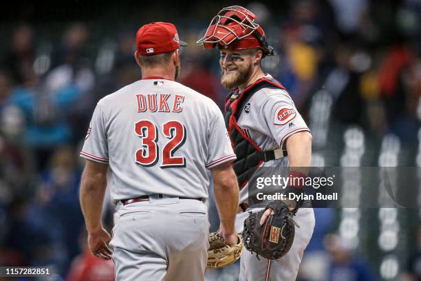 Zach Duke and Tucker Barnhart of the Cincinnati Reds celebrate after beating the Milwaukee Brewers 7-1 at Miller Park on June 20, 2019 in Milwaukee,...