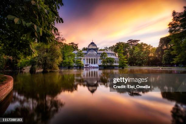 sunset at crystal palace, parque del buen retiro park. madrid, spain - parque del buen retiro stock pictures, royalty-free photos & images