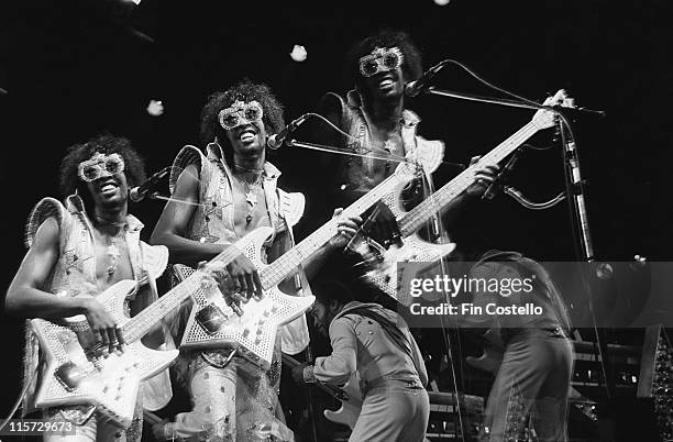 Triple exposure of Bootsy Collins, US funk bassist, playing a star-shaped bass guitar on stage during a live concert performance at the Hammersmith...