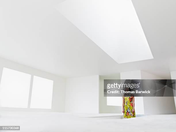 woman standing in stairwell looking up at skylight - caucasian appearance photos stock pictures, royalty-free photos & images