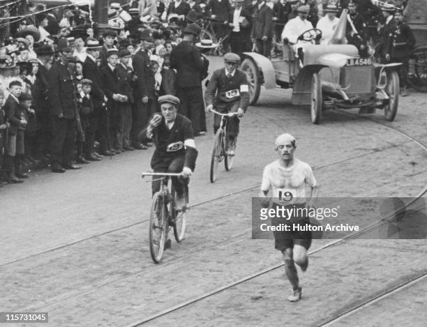Italian athlete Dorando Pietri approaches the White City Stadium at the end of the marathon, during the 1908 Summer Olympics in London, 24th July...
