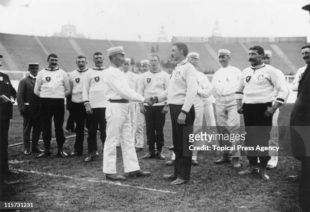 The captains of the Swedish and English tug-of-war teams shake hands at Crystal Palace, during the 1908 Summer Olympics in London, July 1908.