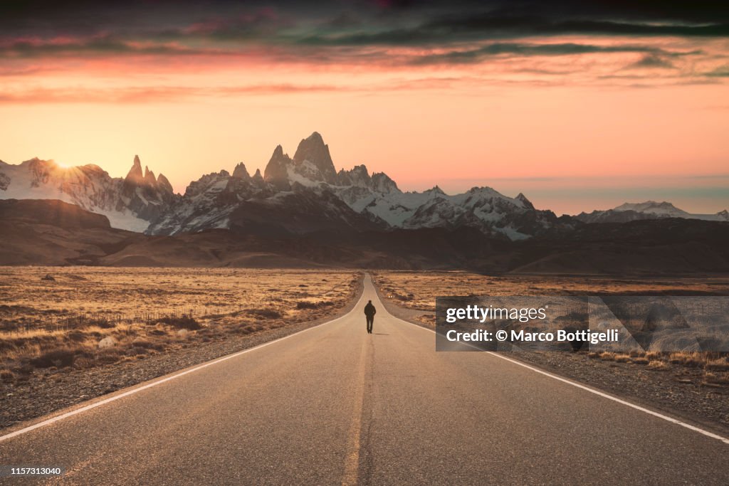 Man walking alone on the road to Fitz Roy, Patagonia Argentina