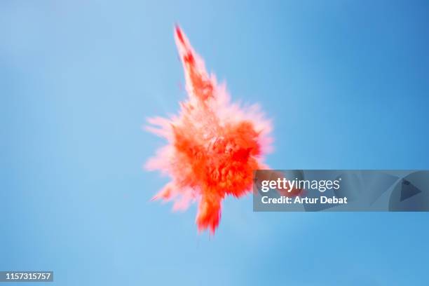 beautiful red powder explosion in the sky. - the big bang theory stock-fotos und bilder