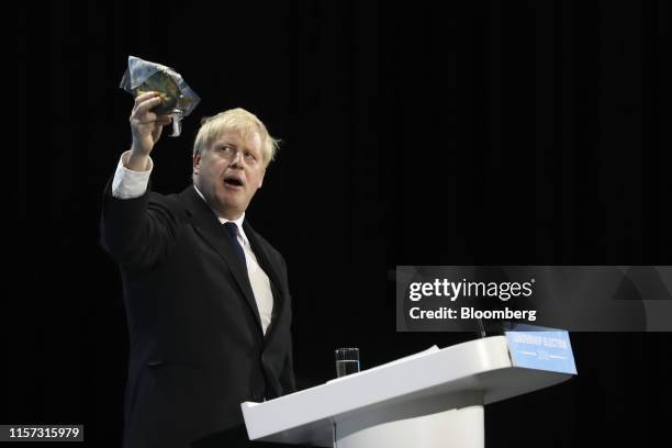 Boris Johnson, former U.K. Foreign secretary, holds a kipper in the air during a speech at the final Conservative Party leadership hustings held at...