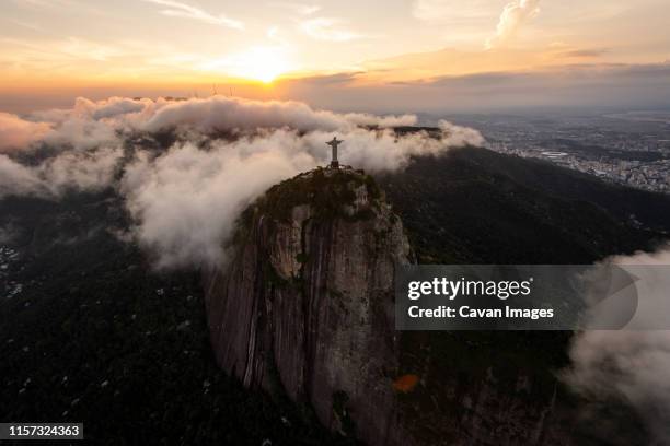 aerial view from helicopter to christ the redeemer statue on mountain - christ the redeemer rio stock-fotos und bilder