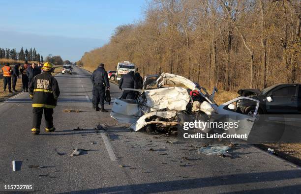 Firefighters work on the wreckage of a Toyota Hilux of Napoli's Argentine soccer player Hugo Campagnaro which crashed with another car in the route...