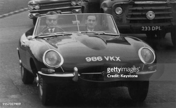 Mohammad Reza Pahlavi , Shah of Iran, test-driving a Jaguar E-Type sports car on the Chertsey Road, near Richmond, Surrey, 1st May 1962. Two embassy...