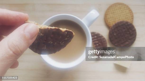 women enjoying a cup of tea and cookies - dipping stock pictures, royalty-free photos & images