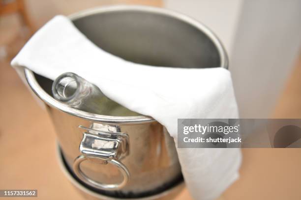 bottle of champagne in an ice bucket - champagne flute high angle stock pictures, royalty-free photos & images