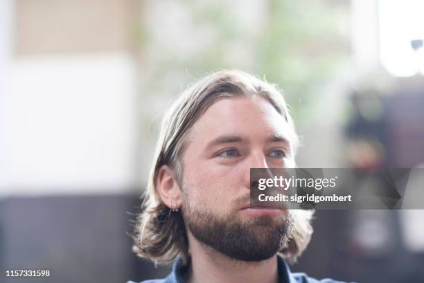 portrait of a man pursing his lips - angry faces stock-fotos und bilder