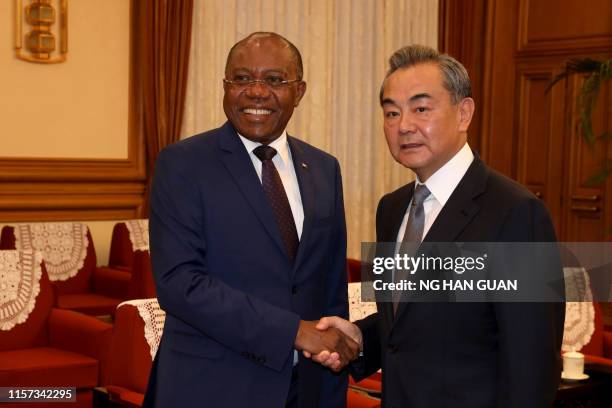 China's Foreign Minister Wang Yi welcomes Angola's Foreign Minister Manuel Domingos Augusto at the Zhongnanhai leadership compound in Beijing on July...