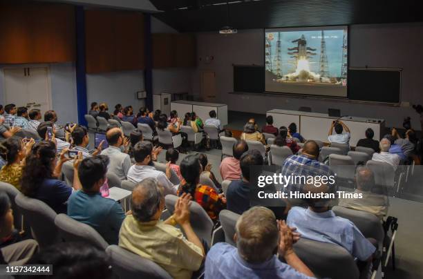 Research scholars and scientists watch the live telecast of launch of 'Chandrayaan-2' at IUCAA in SPPU, on July 22, 2019 in Pune, India. The...