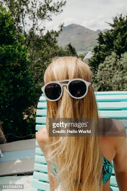 oddball portrait of blond hair brushed forwards with sunglasses over - se cacher photos et images de collection