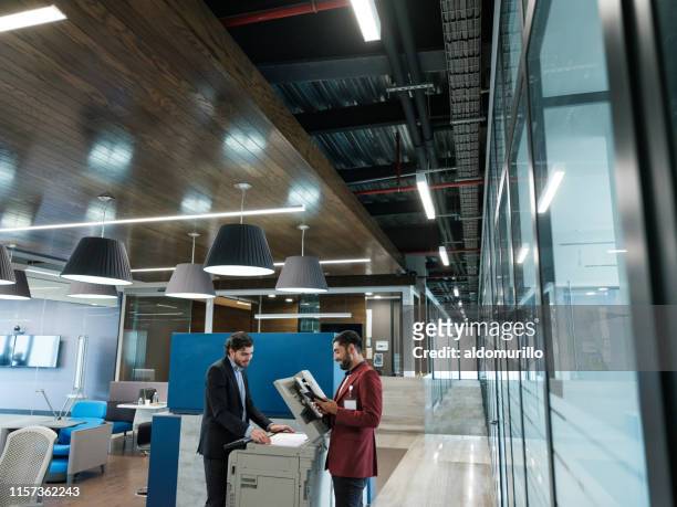 office worker waiting turn to use copy machine - impressora de computador imagens e fotografias de stock