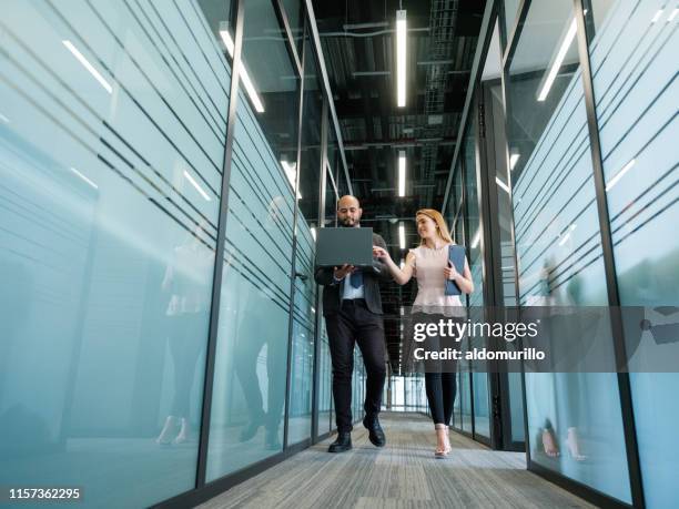 business people walking with laptops - man walking low angle stock pictures, royalty-free photos & images