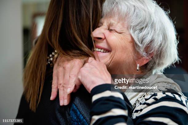 senior grand-mother and adult grand-daughter hugging. - celebration photos bildbanksfoton och bilder
