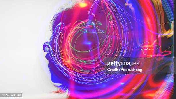 head of beautiful woman with double exposure of abstract lighting trails - double exposure face stock-fotos und bilder