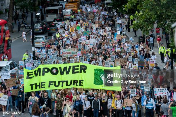 The march of striking school students proceeds down Northumberland avenue towards Embankment on June 21, 2019 in London, England. School students...