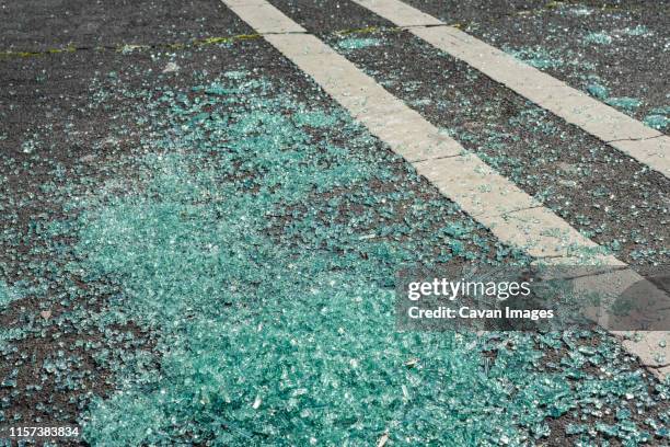 broken glass on ground in parking lot - broken glass car stock pictures, royalty-free photos & images