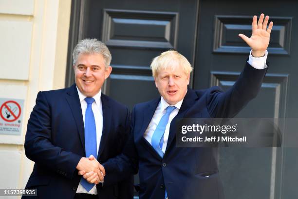 Newly elected leader of the Conservative party Boris Johnson shakes hands with Chairman of Conservative Party Brandon Lewis as he arrives at...