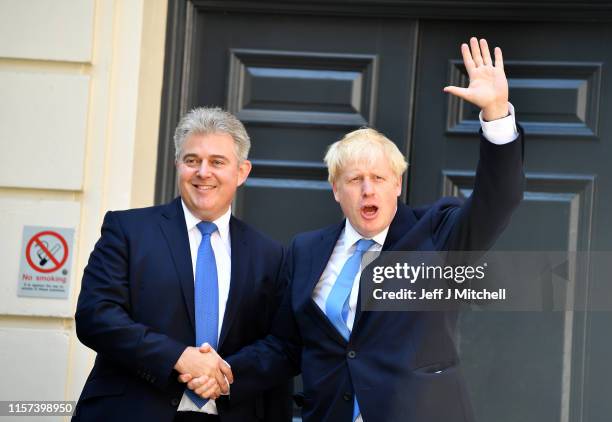 Newly elected leader of the Conservative party Boris Johnson shakes hands with Chairman of Conservative Party Brandon Lewis as he arrives at...