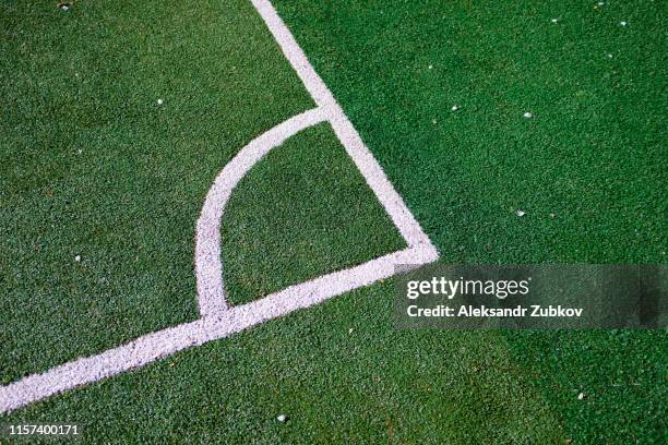 part of the layout of the football field, the position of the corner kick. white marking lines on the green grass of the sports stadium. - american football stadium background fotografías e imágenes de stock