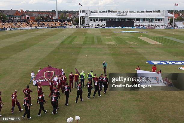 The teams walks onto the pitch during the Friends Life T20 match between Northamptonshire and Durham at Wantage Road on June 9, 2011 in Northampton,...