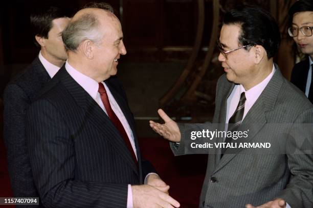 Chinese Prime Minister Li Peng exchanges greetings with Soviet leader Mikhail Gorbatchev prior to their meeting at the Great Hall of the People in...
