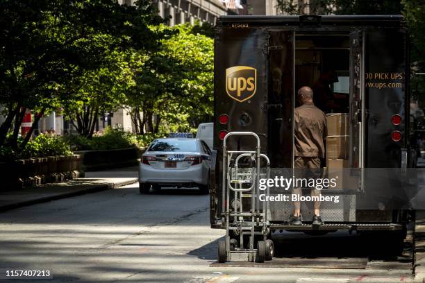 United Parcel Service Inc. Delivery driver unloads packages from a delivery truck in Chicago, Illinois, U.S., on Monday, July 22, 2019. UPS is...