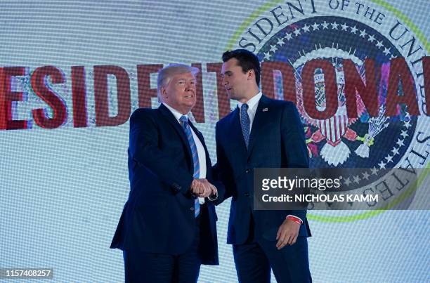 President Donald Trump shakes hands with Charlie Kirk, head of Turning Point USA, before addressing the Turning Point USAs Teen Student Action Summit...