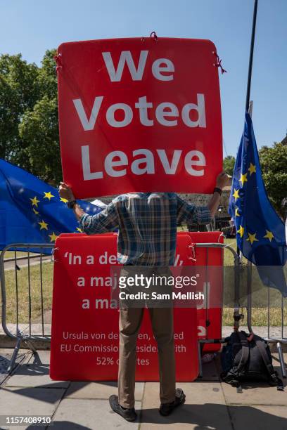 Man holds a huge sign with the words We Voted Leave outside Westminser on the 23rd July 2019 in London in the United Kingdom.