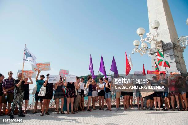 People take part in a protest against the shooting of Woody Allen's new film in the Spanish Basque city of San Sebastian on July 23, 2019. - The...