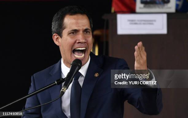 Venezuelan opposition leader and self-proclaimed interim president Juan Guaido gestures as he speaks after voting for rejoining the Inter-American...