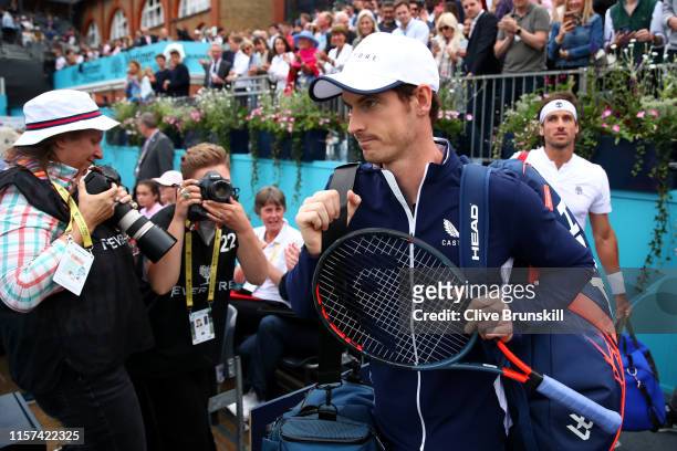 Andy Murray of Great Britain and playing partner Feliciano Lopez of Spain make their way onto centre court prior to their Quarter-Final Doubles Match...