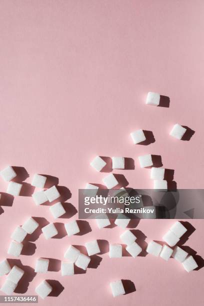 sugar cubes on pink background - sugar cube stock pictures, royalty-free photos & images