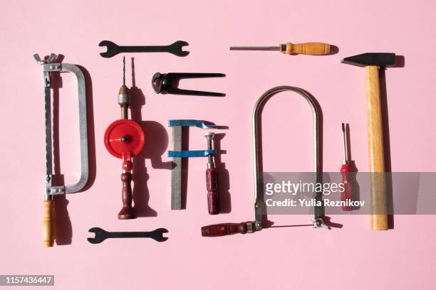 working tools arranged on pink background - adjustable wrench stock-fotos und bilder