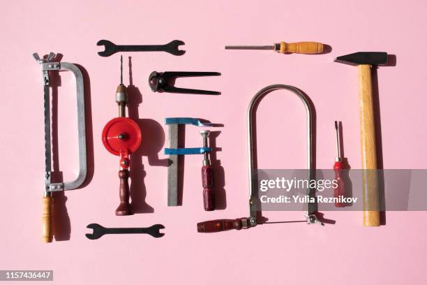 working tools arranged on pink background - adjustable wrench stockfoto's en -beelden