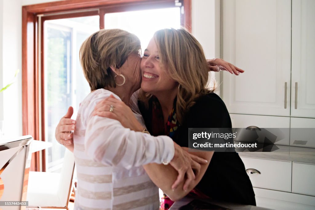 Senior mother and mature daughter hugging.
