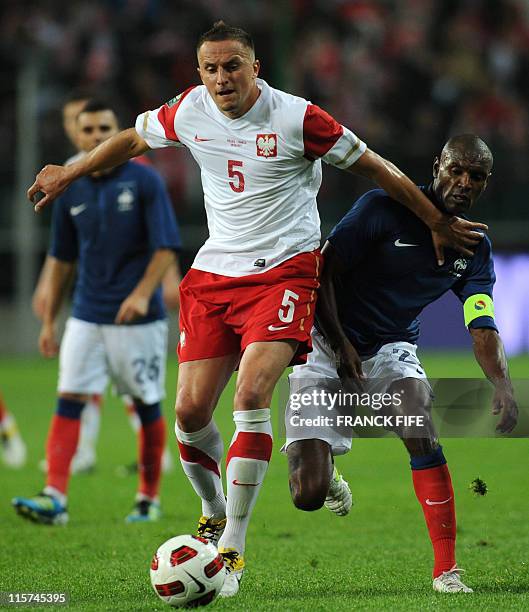 French captain Eric Abidal vies with Poland's defender Dariusz Dudka during the EURO 2012 friendly football match Poland vs France on May 9, 2011 at...
