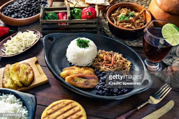 venezuelan traditional food, pabellon criollo with arepas, casabe and papelon with lemon drink - venezuela stock pictures, royalty-free photos & images