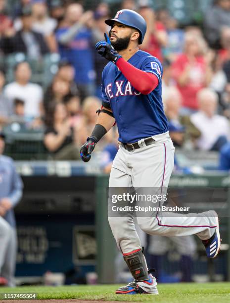 Nomar Mazara of the Texas Rangers celebrates as he rounds the bases after hitting a solo home run off of starting pitcher Tommy Milone of the Seattle...