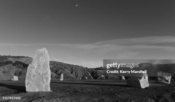 The moon sets as the sun starts to illuminate the stones at the Hakikino Conservation Reserve on June 22, 2019 in Waimarama, New Zealand. The Mātai...