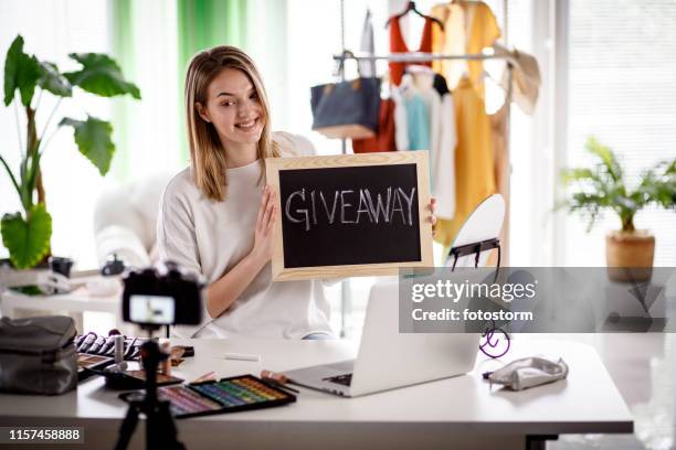beauty and fashion vlogger creating giveaway campaign - giveaway stock pictures, royalty-free photos & images