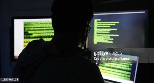 July 2019, Berlin: A man sits in front of three screens with text. Photo: Annette Riedl/dpa-Zentralbild/dpa