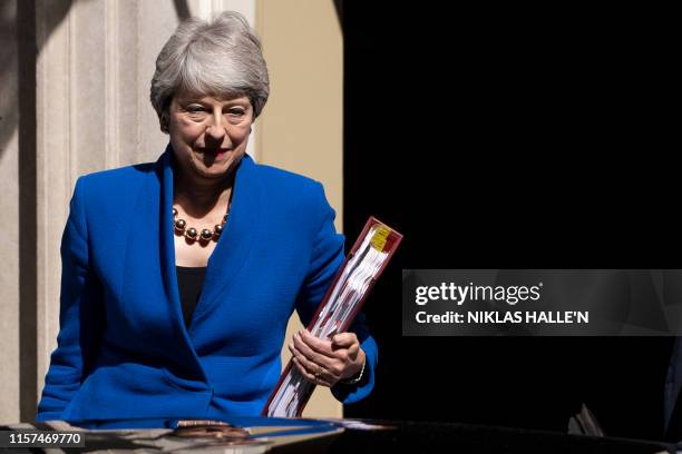 Britain's outgoing prime minister Theresa May leaves 10 Downing street to take part in her final Prime Minister Question session in the House of...