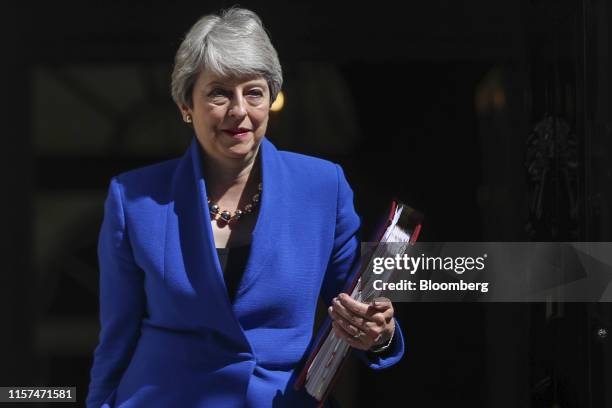 Theresa May, U.K. Prime minister, departs number 10 Downing Street to attend here final weekly questions and answers session in Parliament in London,...